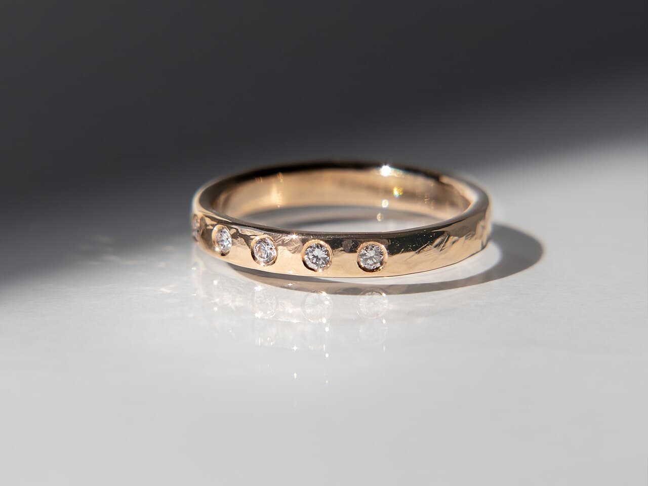 Gold band set with a line of small flush-set diamonds