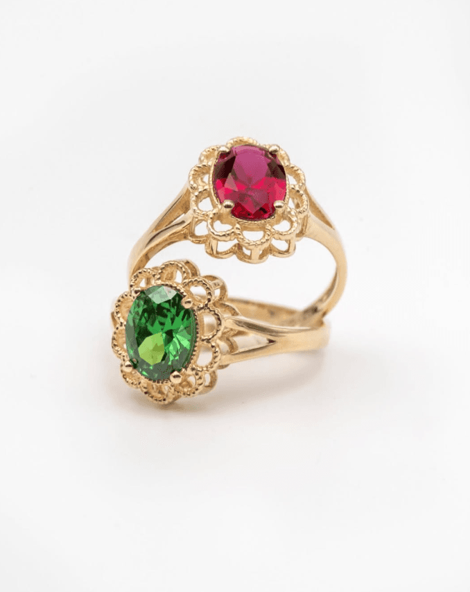Gold rings set with a ruby and an emerald