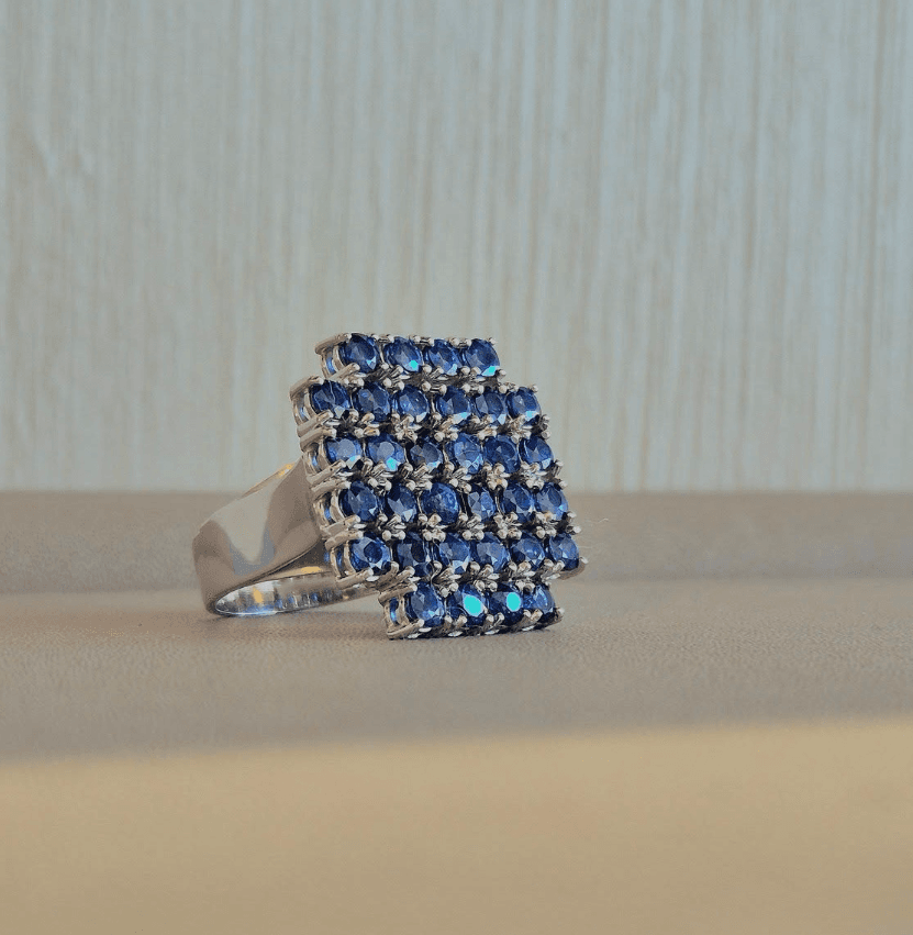 White gold ring set with a cluster of blue sapphires
