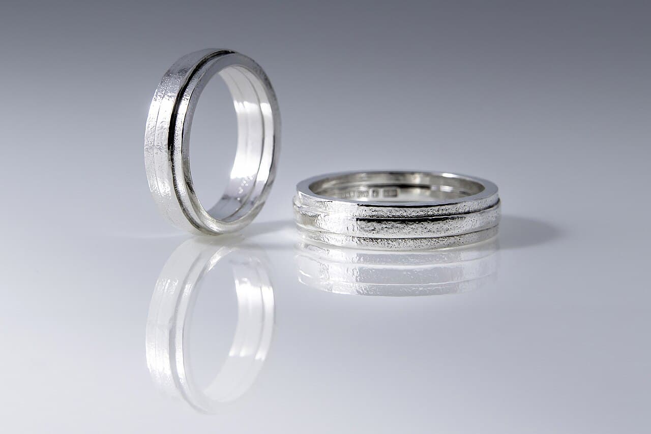 A pair of hand-textured silver bands